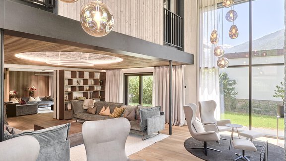 Ein modernes Wohnzimmer mit eleganten Möbeln und großen Fenstern. Die stilvolle Beleuchtung und der offene Raum schaffen eine einladende Atmosphäre. - Chalet White Pearl by MYALPS - Sölden