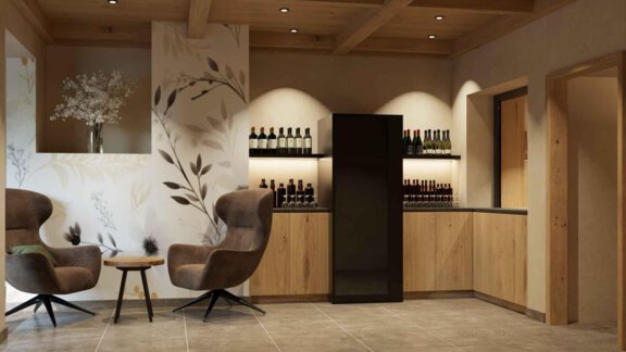 Ein eleganter Innenraum mit zwei bequemen Stühlen und einer Holztheke. Im Hintergrund sind Flaschen ordentlich aufgestellt, um eine einladende Atmosphäre zu schaffen. - Hotel Garni Hainbacherhof - Sölden