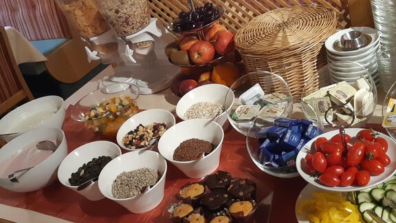 A hearty breakfast buffet with various cereals, yogurt, fresh fruit, and snacks. Healthy options such as vegetables and treats are also available. - Mein Weisskugel - Vent