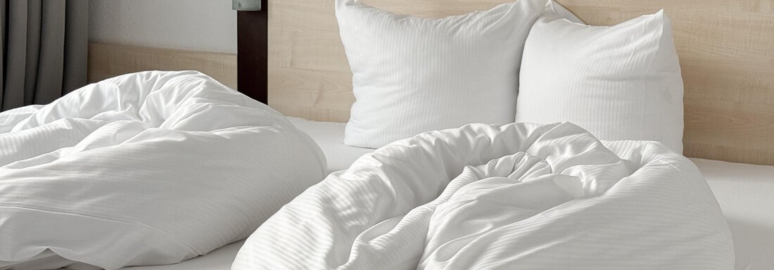 A comfortable bed with white pillows and blankets. The bedding looks fresh and inviting. - Appartementhaus A CASA "Kristall" - Sölden