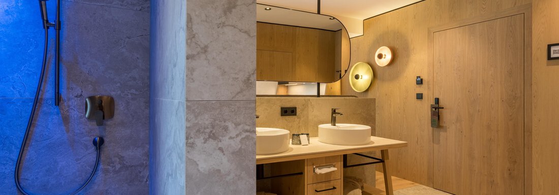 Ein modernes Badezimmer mit einer Dusche und einem stilvollen Waschbecken. Die Wände sind in warmen Holz- und Grautönen gehalten. - Hotel Alpina - Sölden