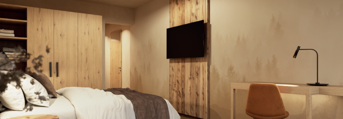 Ein stilvolles Schlafzimmer mit einem gemütlichen Bett und einer Holzkommode. An der Wand befindet sich ein Fernseher und ein Schreibtisch mit einem orangefarbenen Stuhl. - Hotel Garni Hainbacherhof - Sölden